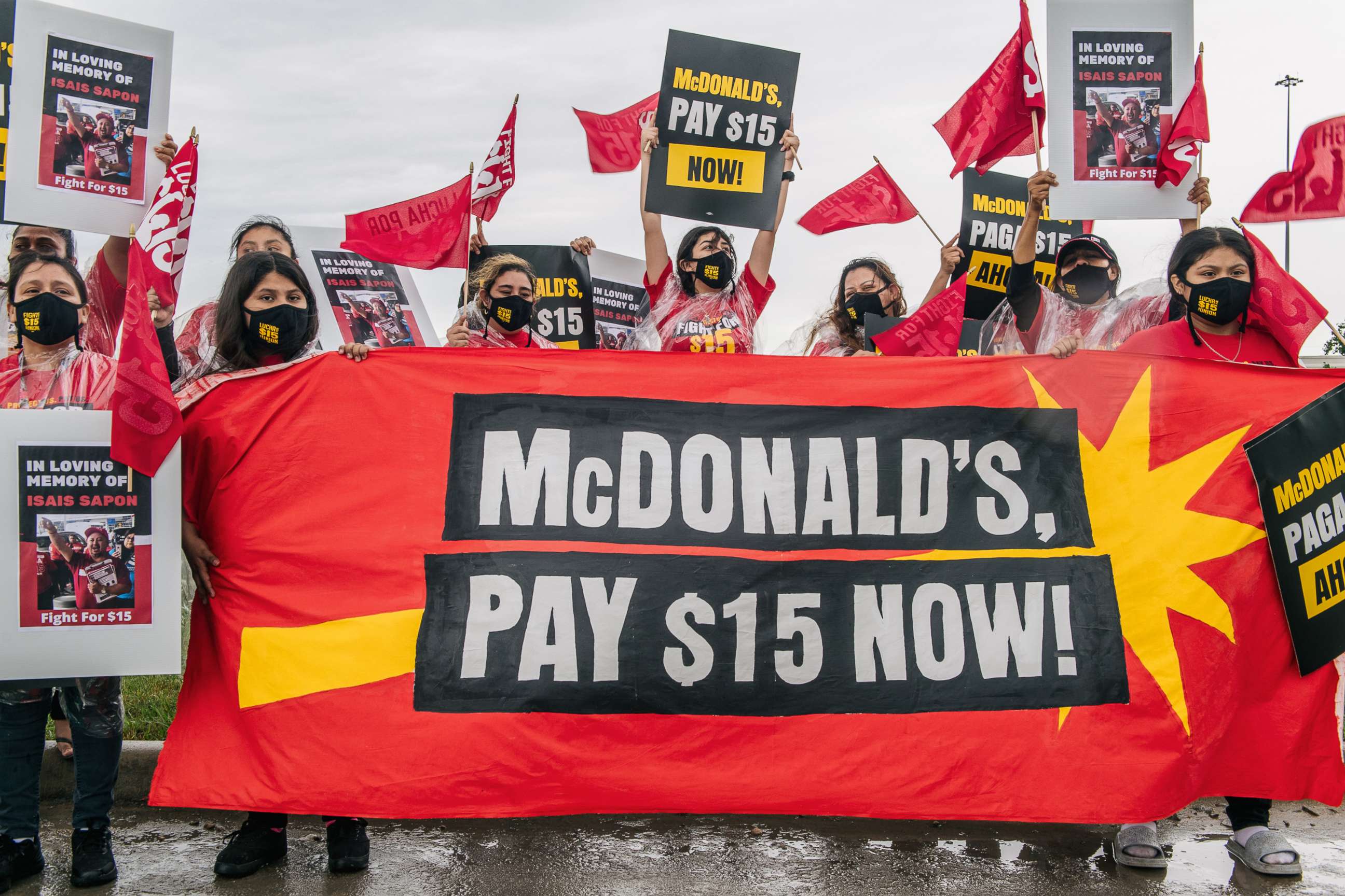 PHOTO: Women chant and display banners during a rally on May 19, 2021 in Houston. Fast-food workers, community members, and activists gathered nationwide to demand McDonald's to raise its minimum wage to $15 an hour.