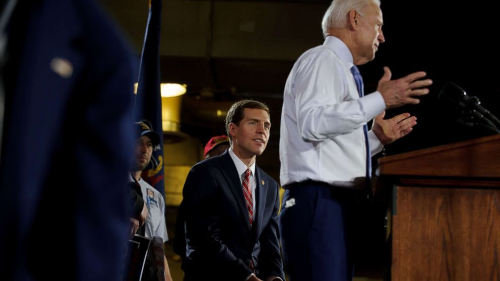 PHOTO: Democratic congressional candidate Conor Lamb listens as former Vice President Joe Biden speaks at a rally in support of, March 6, 2018, at the Union Carpenters Training Center in Pittsburgh, Penn. 