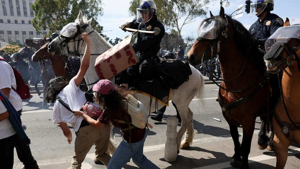 PHOTO: Mounted police officers disperse demonstrators during a No Kings Day protest against President Donald Trump's policies, in Los Angeles, June 14, 2025.  