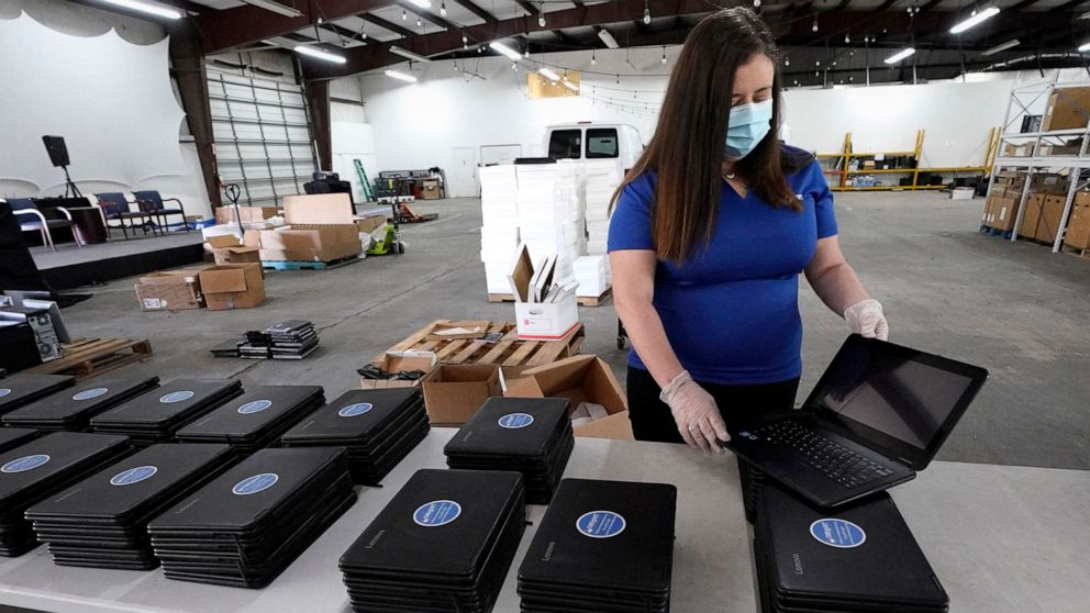 PHOTO: Chief Executive Officer Megan Steckly readies computers to be distributed at Comp-U-Dopt, April 14, 2020, in Houston