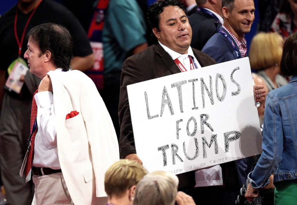 PHOTO:A delegate holds a sign that reads "Latinos For Trump" before the start of the third day of the Republican National Convention on July 20, 2016, in Cleveland.