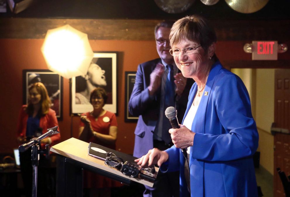 PHOTO: State Sen. Laura Kelly, with her running mate Lynn Rogers behind her, speaks after it was announced that she was the winner in the Democratic race for governor at the Ramada Hotel and Convention Center in Topeka, Kansas,Aug. 7, 2018.