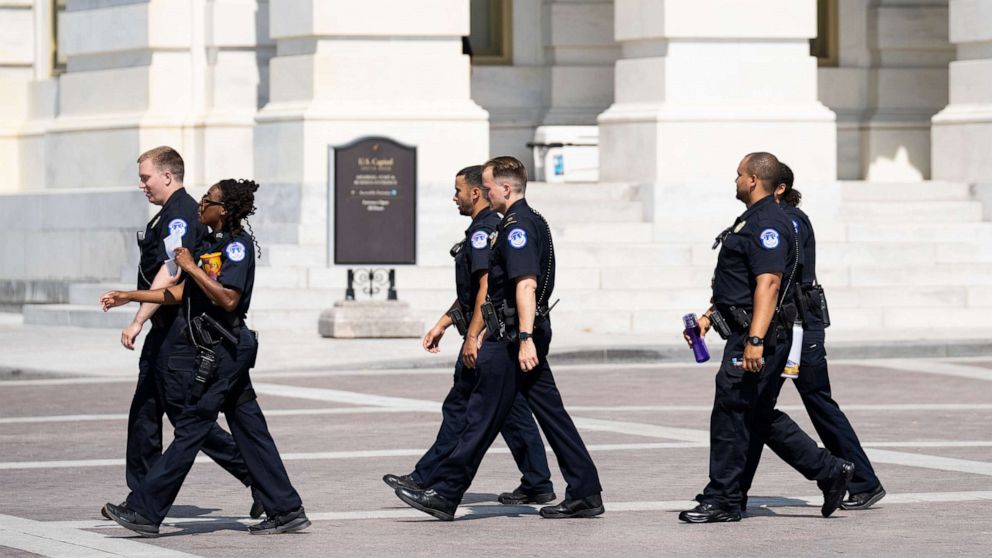 PHOTO: A squad of U.S. Capitol Police officers walks across the East Plaza of the U.S. Capitol, June 13, 2022. 