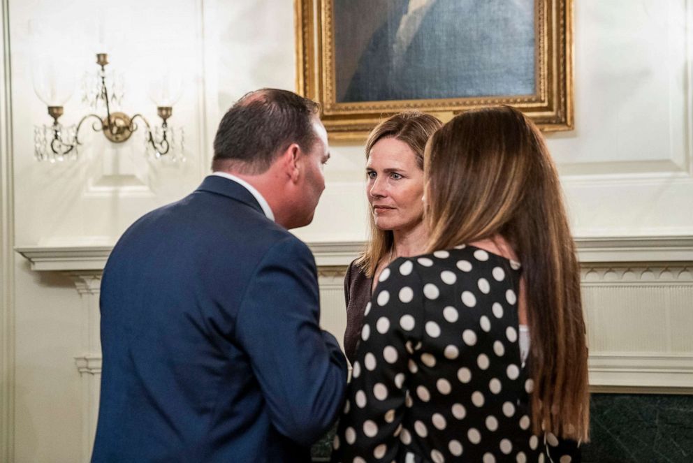 PHOTO: Sen. Mike Lee chats with Judge Amy Coney Barrett, center, at the White House, Sept. 26, 2020, as they attend President Donald Trump's announcement of Barrett's nomination to the Supreme Court.