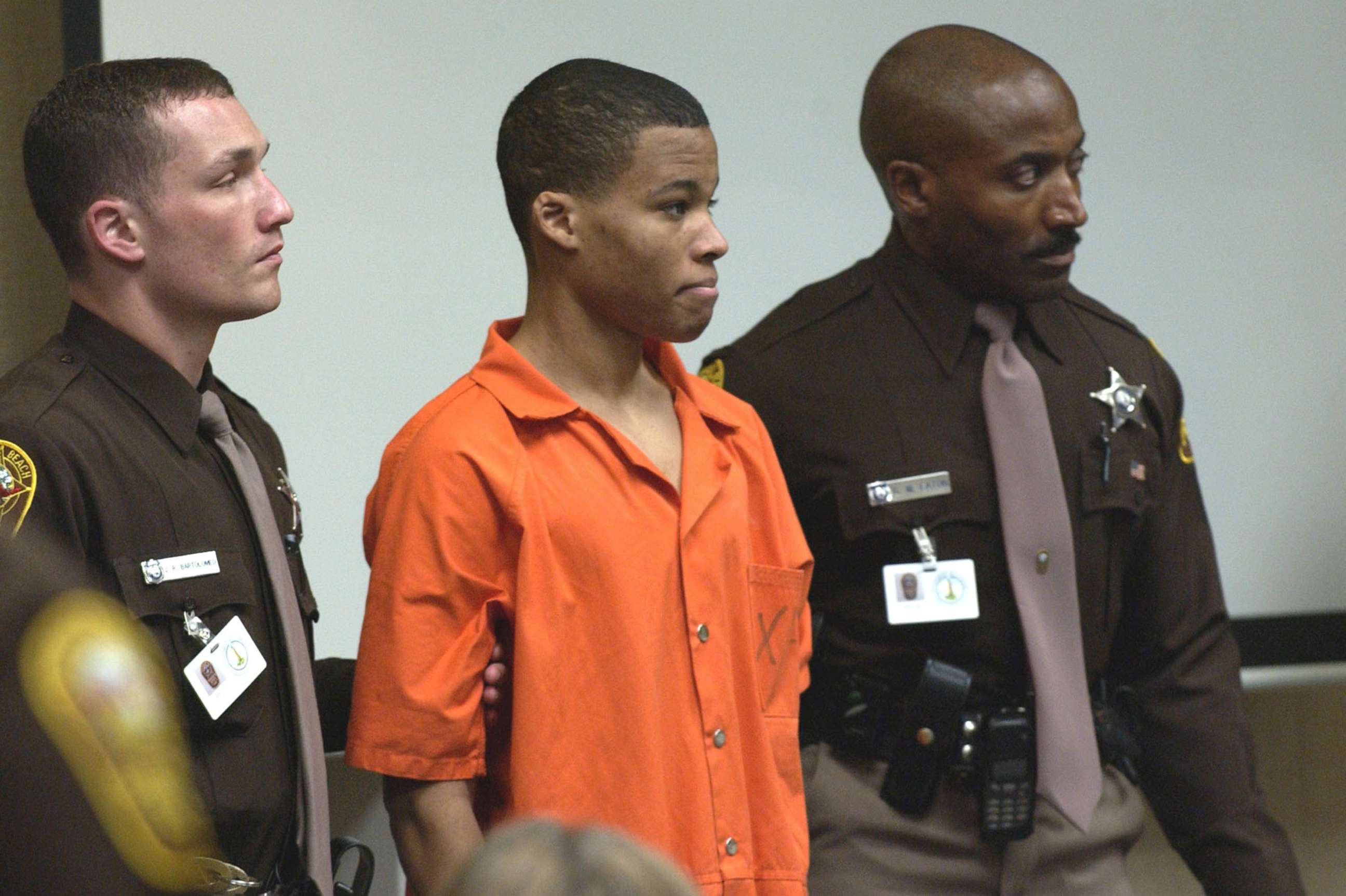 PHOTO: Sniper suspect Lee Boyd Malvo, 18, is surrounded by deputies as he is brought into court to be identified by a witness during the trial of sniper suspect John Allen Muhammad at the Virginia Beach Circuit Court, Oct. 22, 2003.