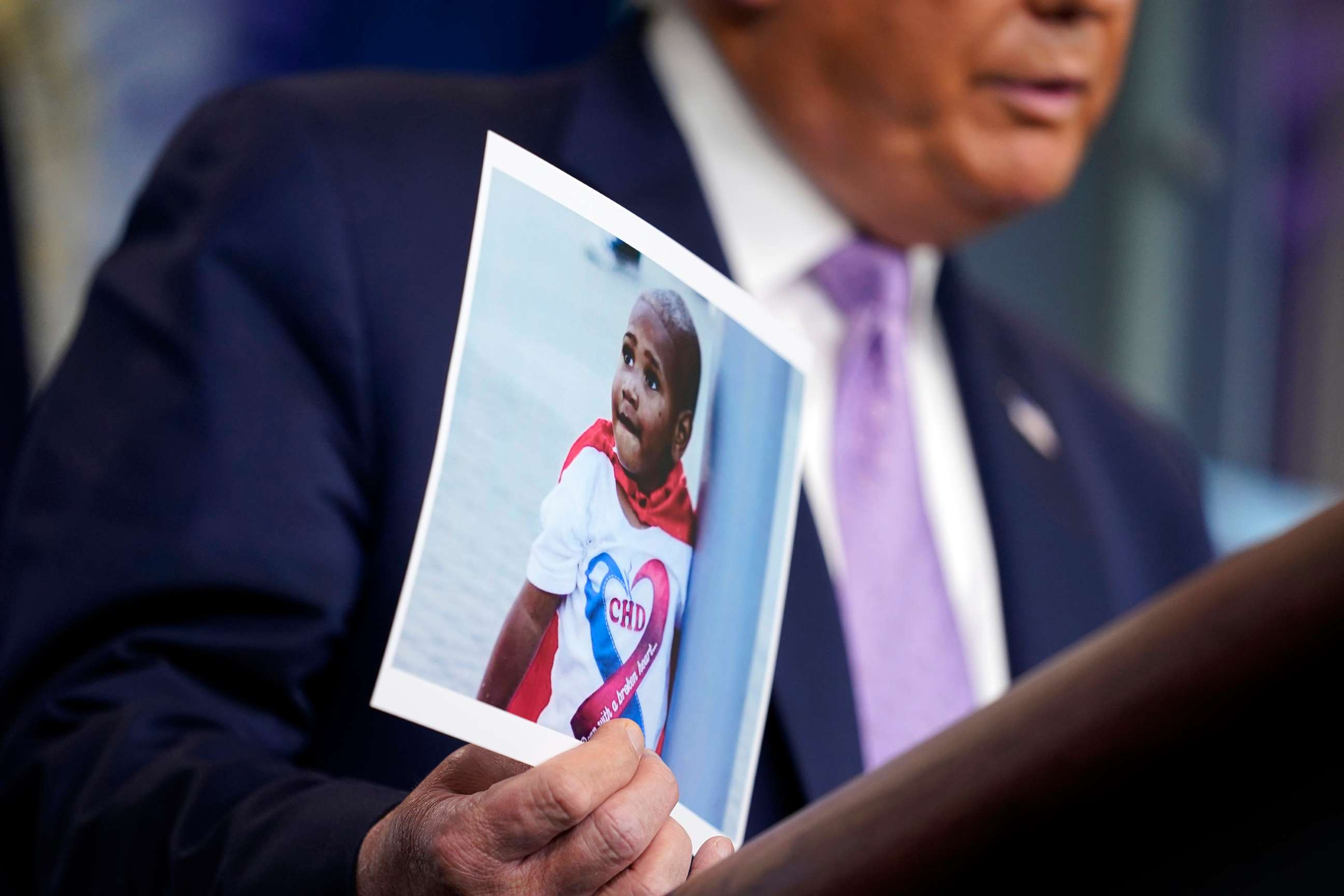 PHOTO: President Donald Trump holds a photo of LeGend Taliferro as he speaks at a news conference in the James Brady Press Briefing Room at the White House, Aug. 13, 2020, in Washington.