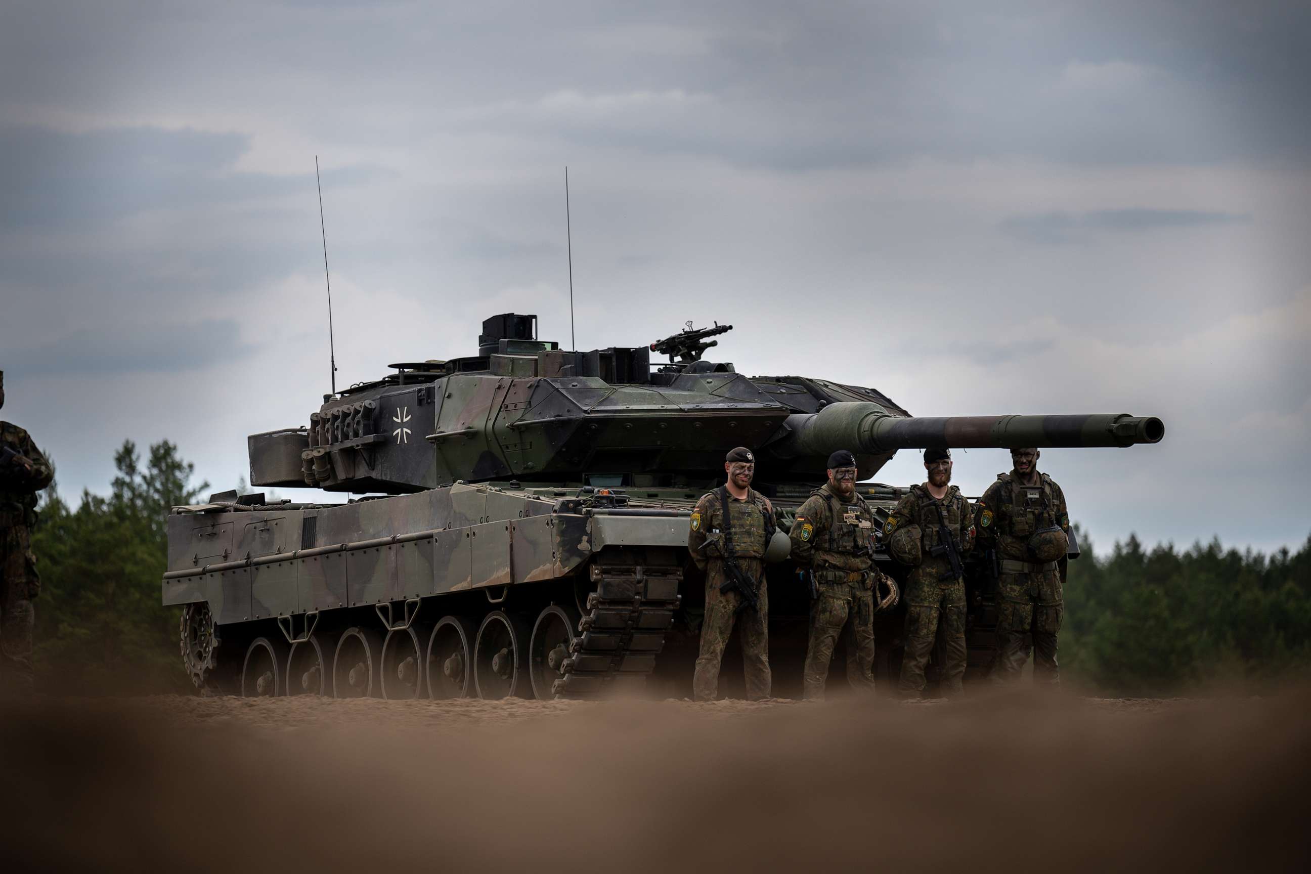 PHOTO: Soldiers stand in front of a German Army Leopard-2 tank used by the NATO Enhanced Forward Presence Battle Group during Chancellor Scholz's visit to Camp Adrian Rohn, June 7, 2022, in Pabrade, Lithuania.