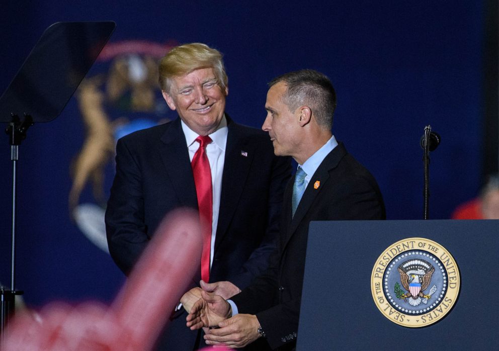 PHOTO: Former Trump Campaign manager Corey Lewandowski speaks as US President Donald Trump looks on during a rally at Total Sports Park in Washington, Michigan on April 28, 2018.