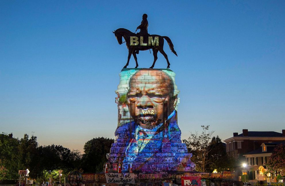 PHOTO: The image of late Rep. John Lewis, a pioneer of the civil rights movement and long-time member of the U.S. House of Representatives, is projected on the statue of Confederate General Robert E. Lee in Richmond, Va., July 19, 2020.