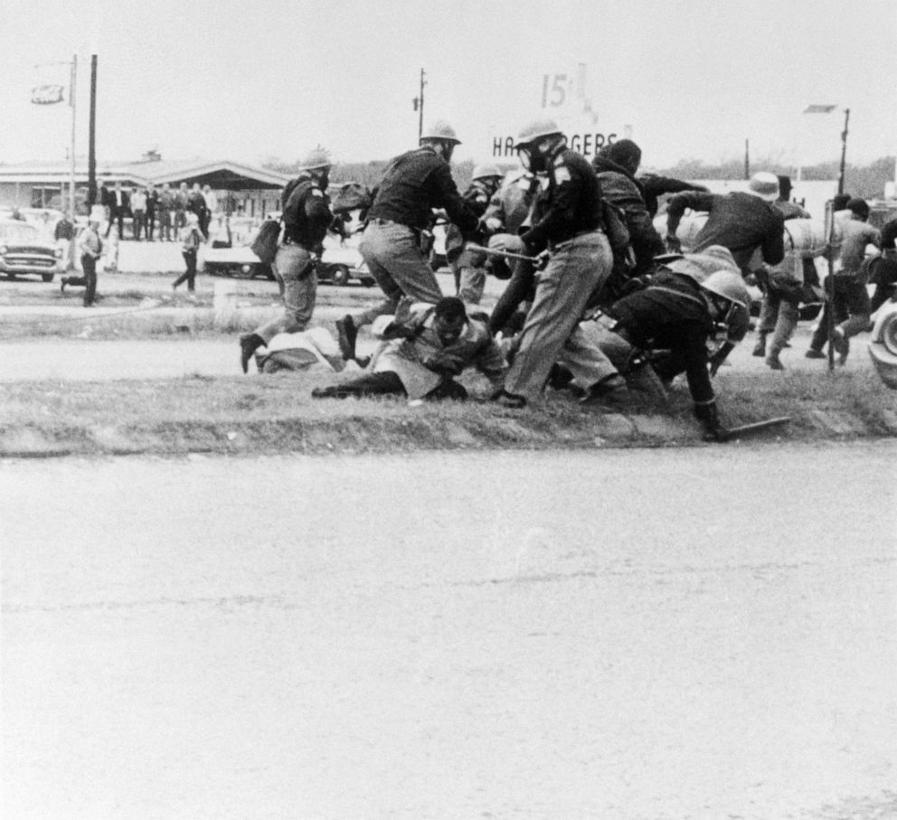 PHOTO: SNCC leader John Lewis (light coat, center), attempts to ward off the blow as a burly state trooper swings his club at Lewis' head during the attempted march from Selma to Montgomery March 7, 1965.