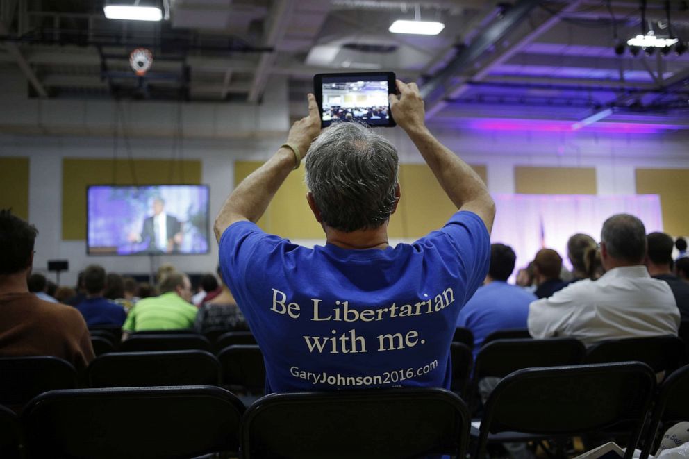 PHOTO: An attendee wearing a T-shirt in support of Gary Johnson, 2016 Libertarian presidential nominee, takes a photograph with a tablet device during a campaign event at Purdue University in West Lafayette, Indiana, U.S., on Tuesday, Sept. 13, 2016.