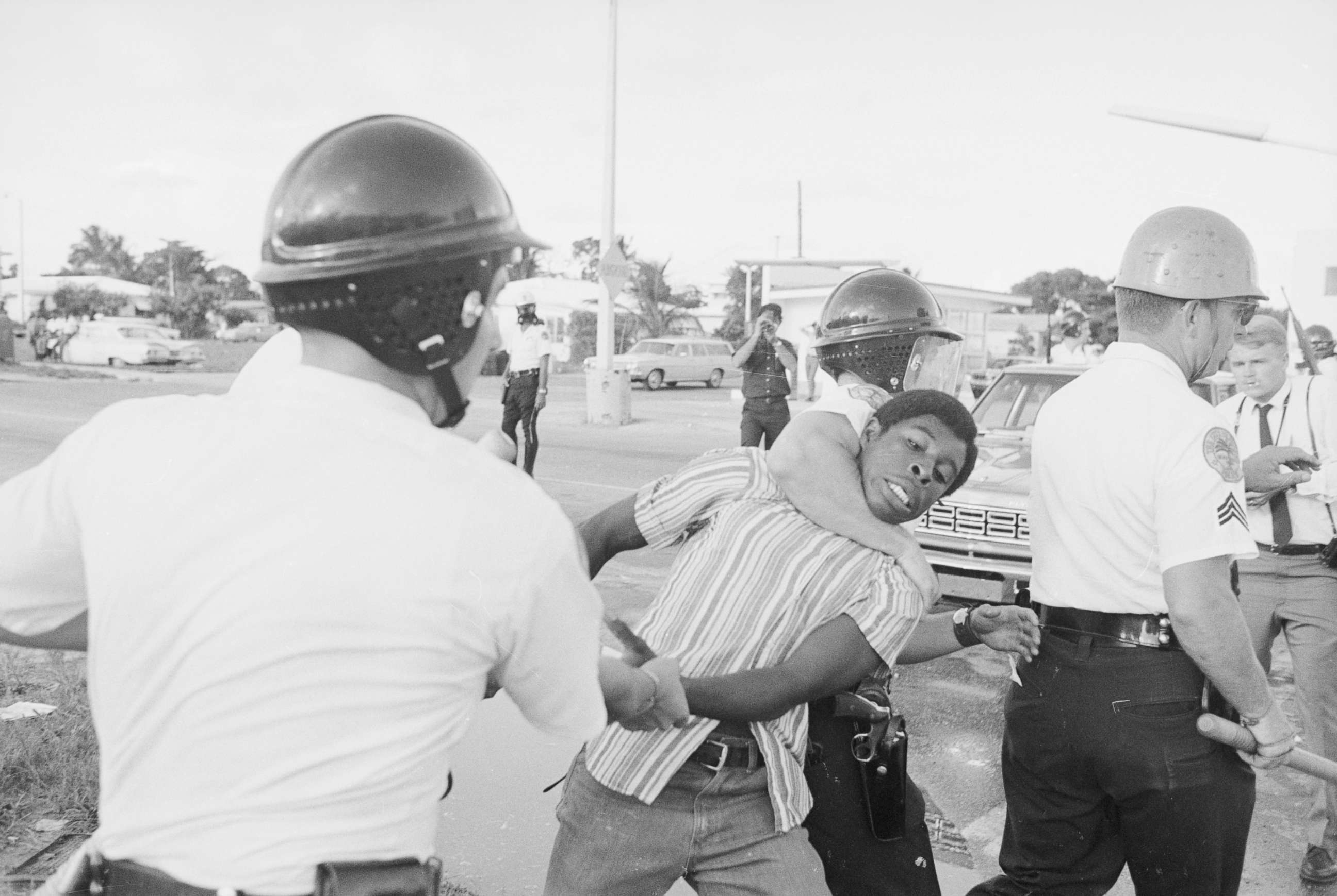 PHOTO: Miami policemen, one holding the man's arm and the other with an arm lock on his neck, drag away a man during a protest in Liberty City district in Miami, Aug. 8, 1968.