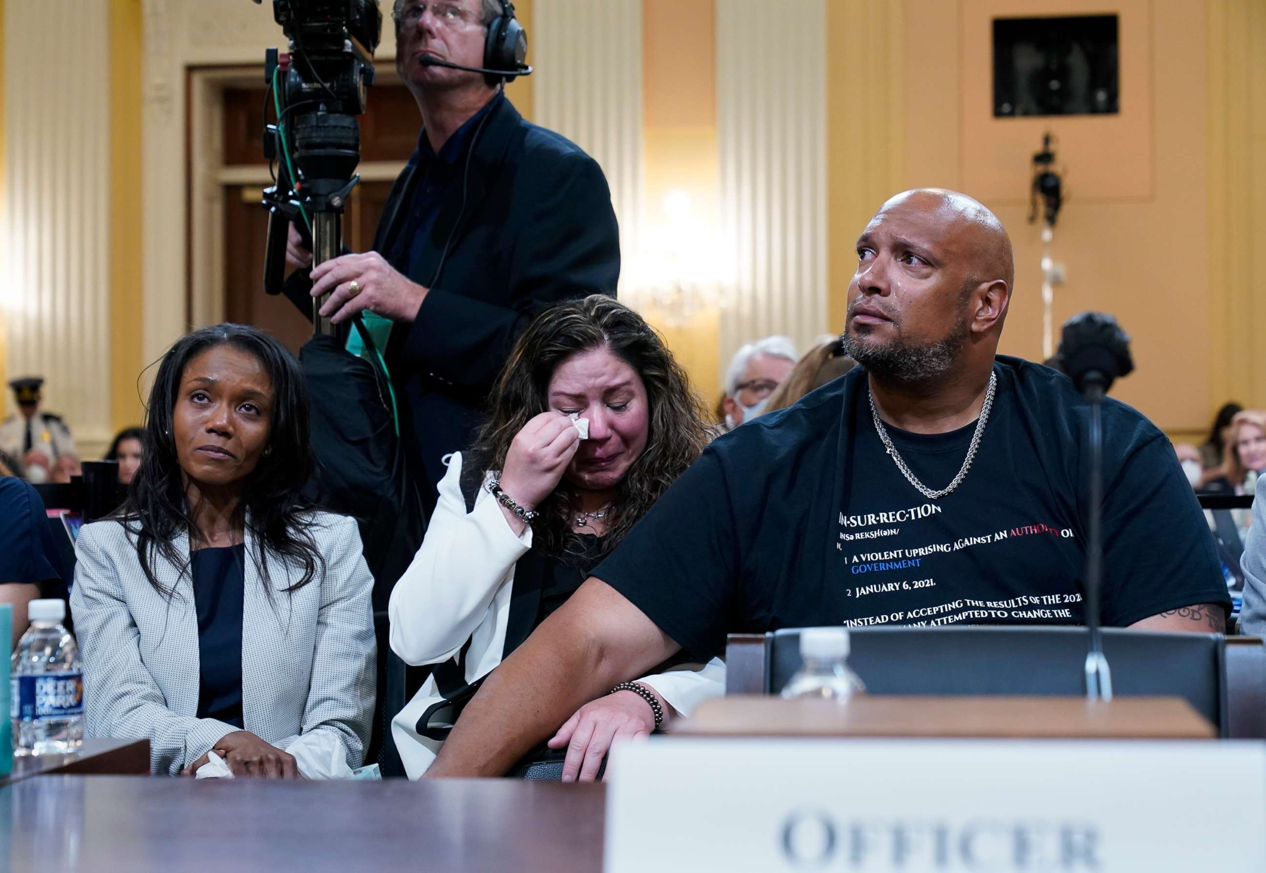 PHOTO: Serena Liebengood, widow of Capitol Police officer Howie Liebengood, Sandra Garza, partner of fallen Capitol Police Officer Brian Sicknick and Capitol Police Sgt. Harry Dunn, watch a video of the Jan. 6 attack during a public hearing, June 9, 2022.