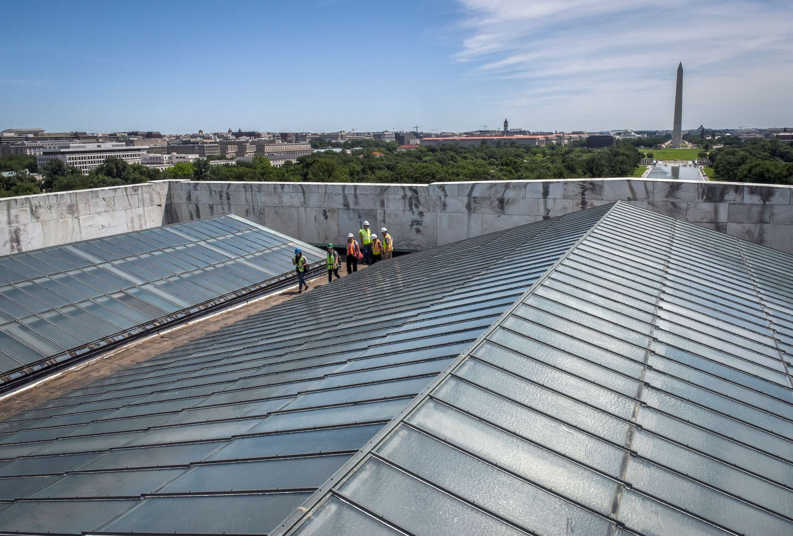 PHOTO: Reporters and officials walk between the skylights on the roof during a tour of on-going work on the rehabilitation of the Lincoln memorial, June, 14, 2018, in Washington, DC.