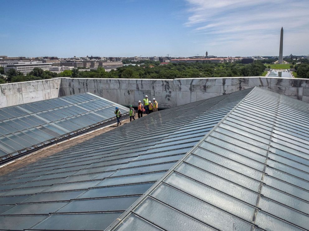 PHOTO: Reporters and officials walk between the skylights on the roof during a tour of on-going work on the rehabilitation of the Lincoln memorial, June, 14, 2018, in Washington, DC.