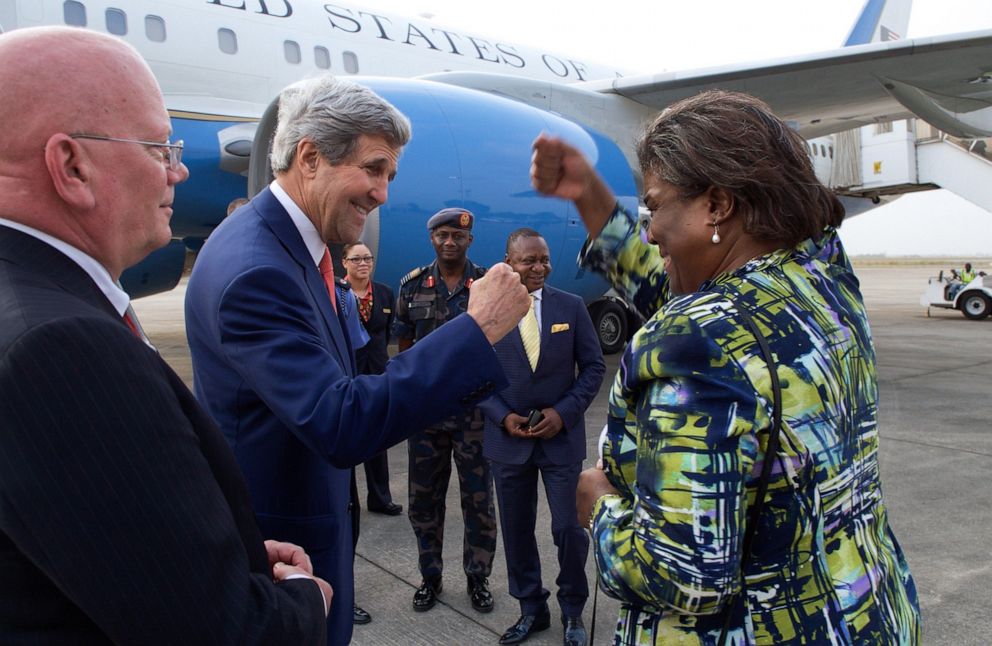 PHOTO: Secretary of State John Kerry fists bumps with Assistant Secretary of State for African Affairs Linda Thomas-Greenfield as she continues he travels on the Continent while he prepares to depart from the airport in Lagos, Nigeria, Jan. 25, 2015.