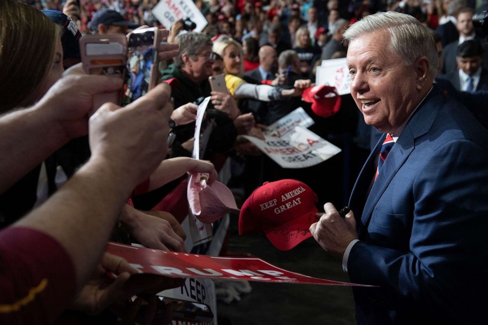 PHOTO: Sen. Lindsey Graham signs a baseball hat and greets supporters during a Keep America Great campaign rally for President Donald Trump at the North Charleston Coliseum in North Charleston, S.C., Feb. 28, 2020.