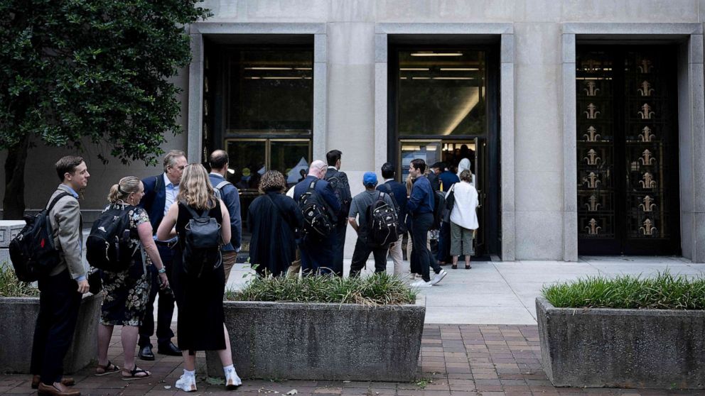 PHOTO: People wait to enter court where former President Donald Trump will appear on charges he conspired to subvert the 2020 presidential election at the E. Barrett Prettyman U.S. Courthouse on Aug. 3, 2023, in Washington, D.C.