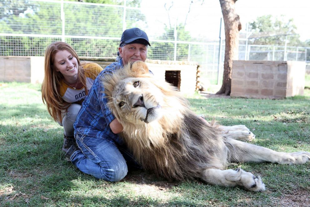 PHOTO: In this Sept. 28, 2016, file photo, Jeff Lowe and Lauren Dropla sit with Jax the lion at the Greater Wynnewood Exotic Animal Park in Wynnewood, Okla.