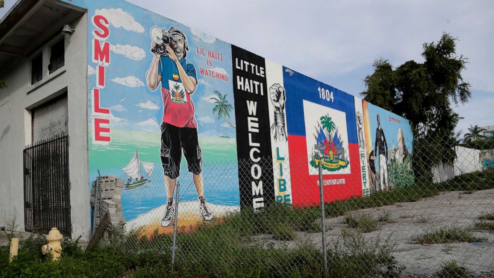 PHOTO: Murals adorn a wall next to a vacant lot in the Little Haiti neighborhood of Miami, July 16, 2019.