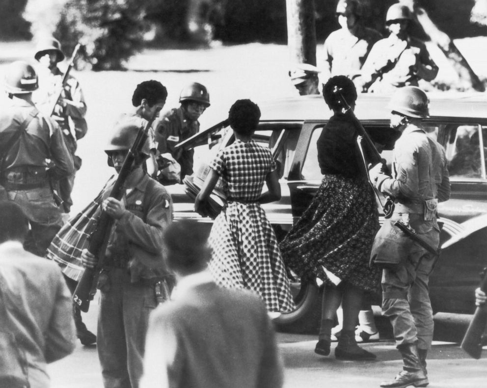 PHOTO: Black students are provided with a military escort when entering and leaving Little Rock Central High School, Ark., following the school's desegregation, 1957. 