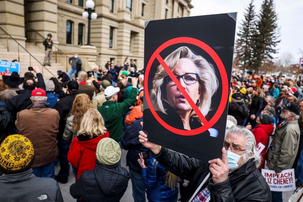 PHOTO: A man holds up a sign against Rep. Liz Cheney as Rep. Matt Gaetz speaks to a crowd during a rally against her in Cheyenne, Wyo., Jan. 28, 2021.
