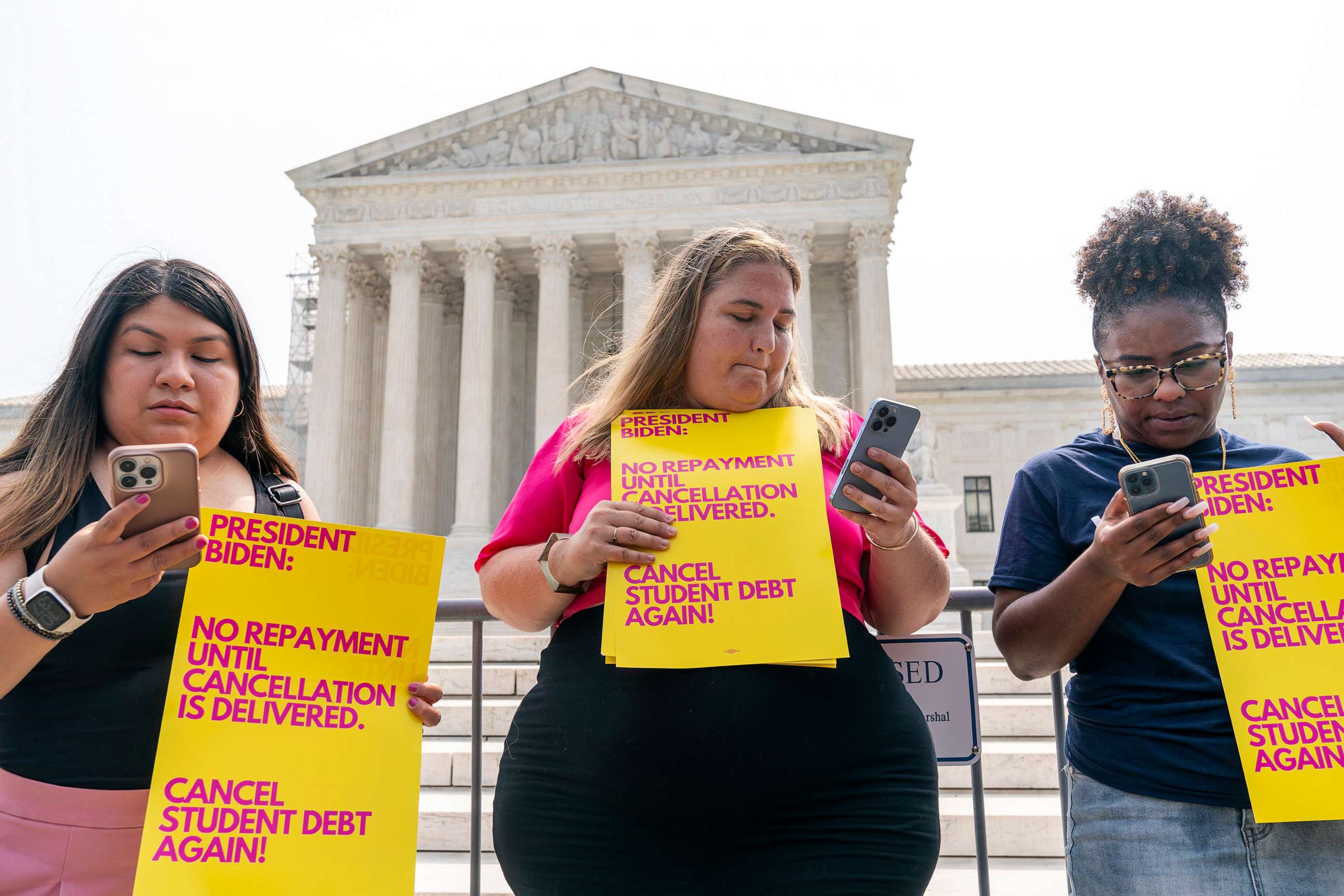 PHOTO: Demonstrators with the group, "We The 45 Million," including Melissa Byrne, center, react as they read the Supreme Court decision on the student loan cancellation program, June 30, 2023, in Washington, D.C.