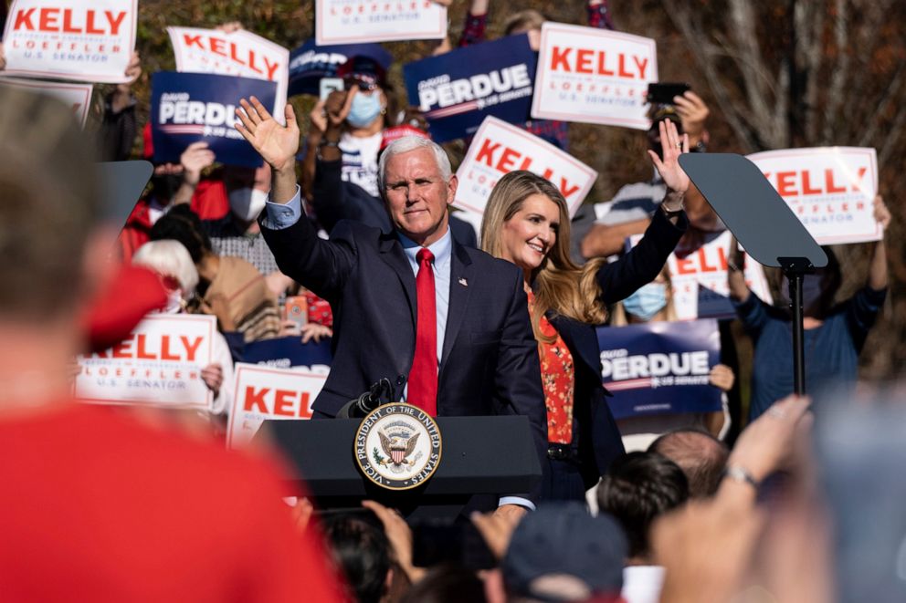 PHOTO: Vice President Mike Pence and Kelly Loeffler wave to the crowd during a Defend the Majority Rally, Friday, Nov. 20, 2020 in Canton, Ga. U.S. Sen. Kelly Loeffler waves behind Pence.