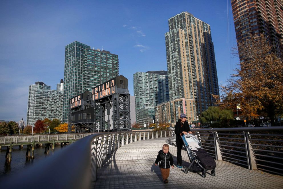 PHOTO: People walk along Gantry Plaza State Park, in Long Island City, New York, Nov. 7, 2018.