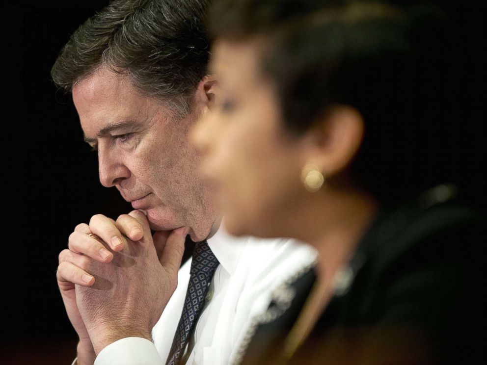PHOTO: FBI Director James Comey listens at left as Attorney General Loretta Lynch speaks during a meeting with members of the media at Justice Department in Washington, D.C., Nov. 19, 2015.