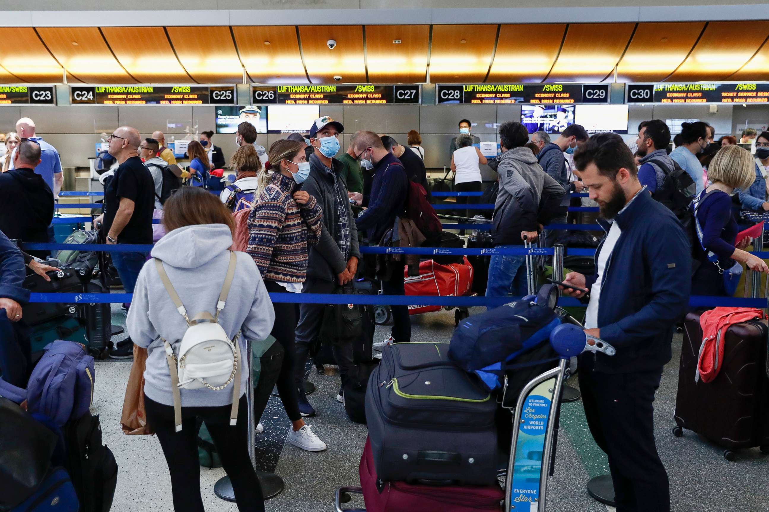 PHOTO: In this May 27, 2022, file photo, travelers wait in check-in lines at Tom Bradley International Terminal at Los Angeles International Airport in Los Angeles.