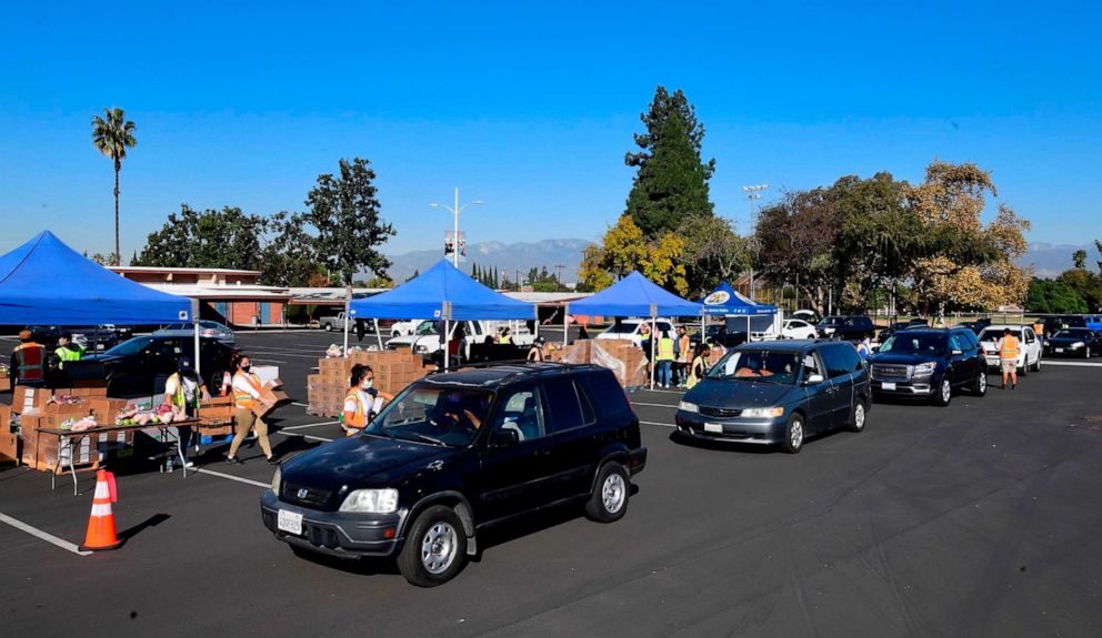 PHOTO: Drivers in their vehicles wait in line on arrival at a "Let's Feed LA County" food distribution hosted by the Los Angeles Food Bank on Dec. 4, 2020, in Hacienda Heights, Calif.