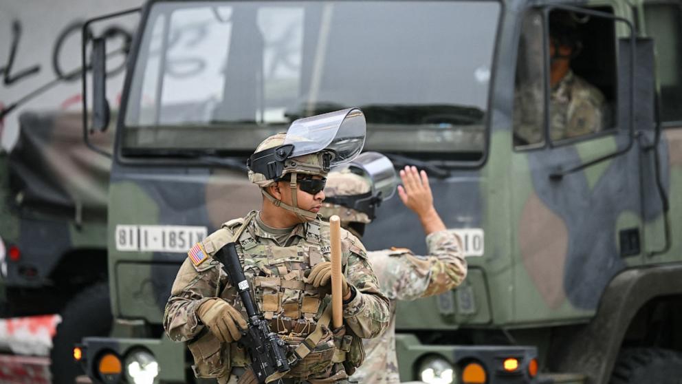 PHOTO: Members of the California National Guard stand watch outside the Edward R. Roybal Federal Building on the morning of June 10, 2025, following another day of protests in response to federal immigration operations in Los Angeles.