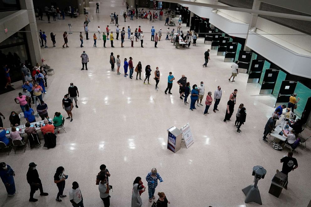 PHOTO: Voters line up as polls open on the day of the primary election in Louisville, Ky., June 23, 2020.