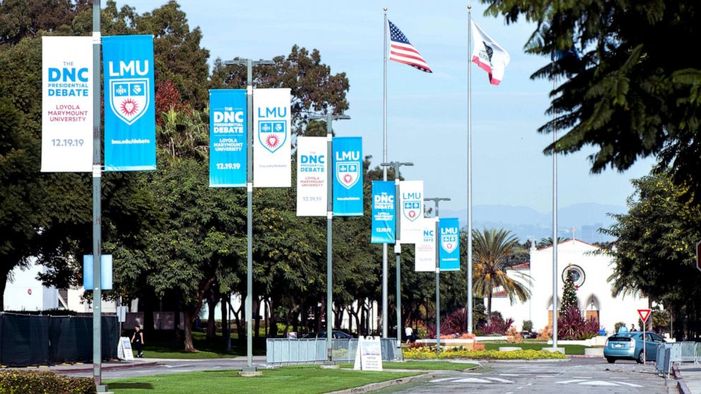 PHOTO: Signage for the sixth Democratic presidential candidates' debate on, co-sponsored by PBS NewsHour and POLITICO and held at Loyola Marymount University's Gersten Pavilion, is seen posted on the campus, Dec. 11, 2019.