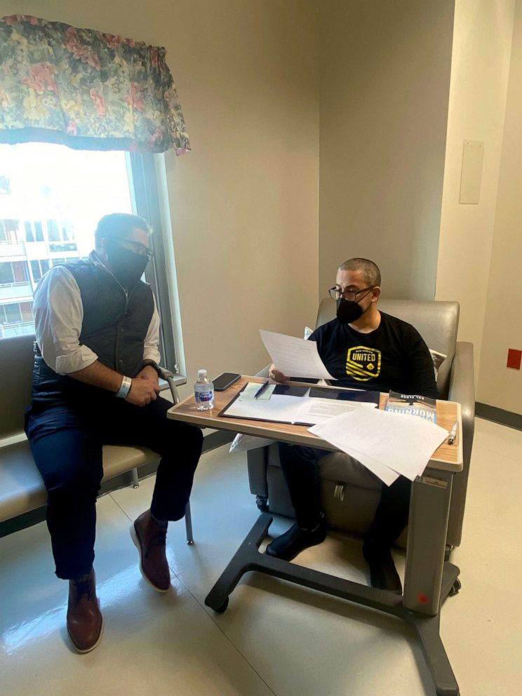 PHOTO: Sen. Ben Ray Lujan seen in the hospital with his chief of staff, Carlos Sanchez, Feb. 16, 2022, in Washington, D.C. 