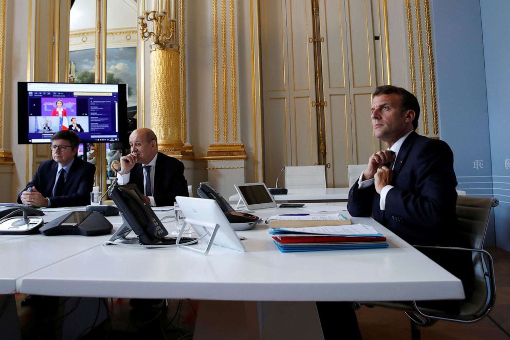 PHOTO: French President Emmanuel Macron (R) attends an international videoconference on vaccination with French Foreign Affairs Minister Jean-Yves Le Drian (C) at the Elysee Palace in Paris, on May 4, 2020.