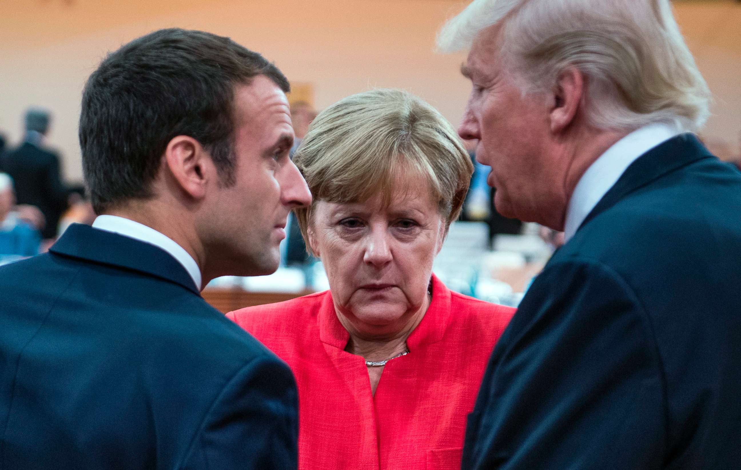 PHOTO: French President Emmanuel Macron, German Chancellor Angela Merkel and US President Donald Trump confer at the start of the first working session of the G20 meeting in Hamburg, Germany, July 7, 2017.