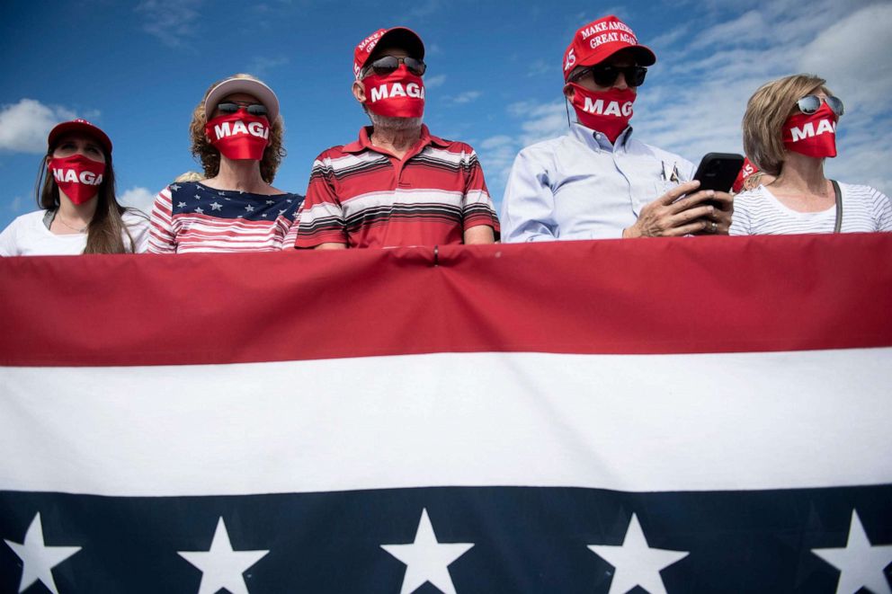 PHOTO: Supporters listen as President Donald Trump speaks at a "Make America Great Again" rally on Oct. 15, 2020, held at Pitt-Greenville Airport in Greenville, N.C.