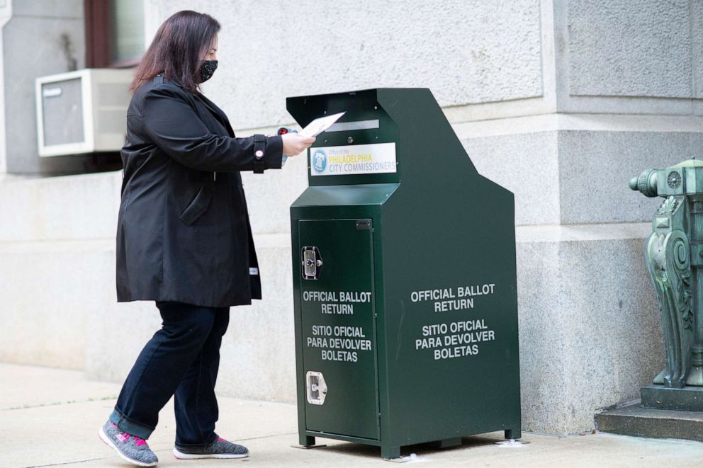 PHOTO: A voter casts her early voting ballot at drop box outside of City Hall, Oct. 17, 2020, in Philadelphia.