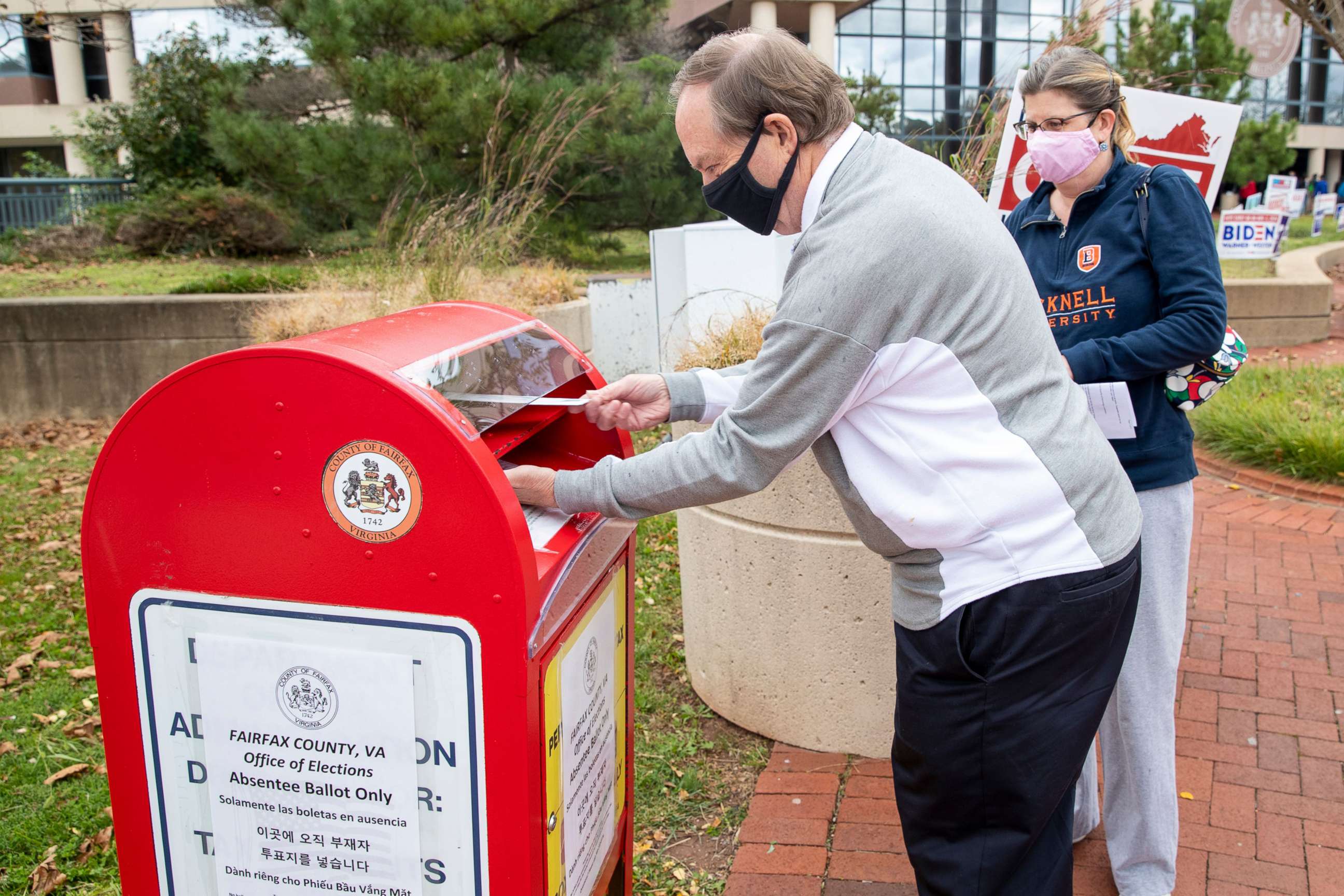 PHOTO: Voters deposit their ballots for the 2020 presidential election in a drop box at the Fairfax County Government Center in Fairfax, Va., Oct. 16, 2020.
