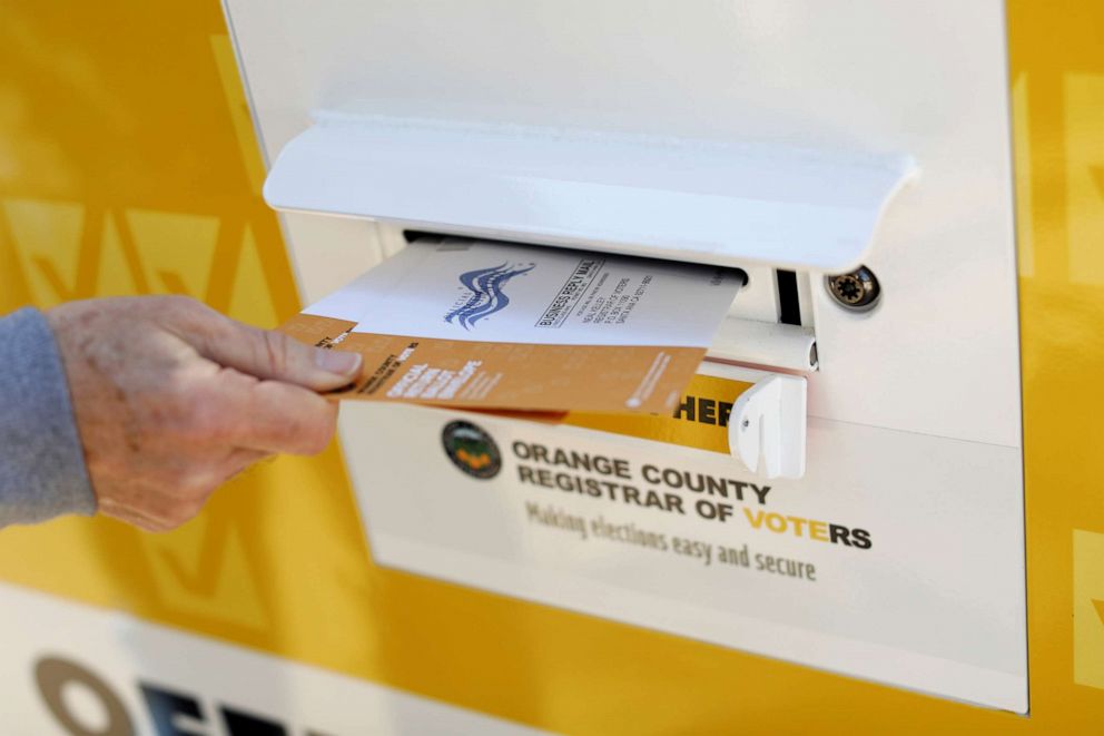 PHOTO: A voter drops ballots for the March 3 Super Tuesday primary into a mobile voting mail box in Laguna Woods, Calif., Feb. 24, 2020.