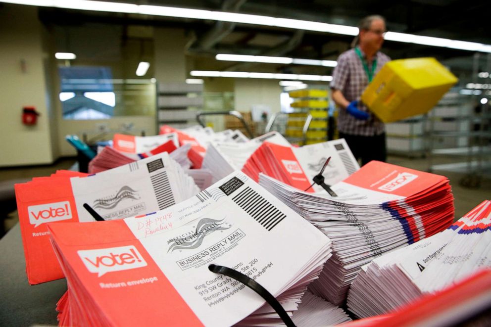 PHOTO: Empty envelopes of opened vote-by-mail ballots for the presidential primary are stacked on a table at King County Elections in Renton, Washington, March 10, 2020.