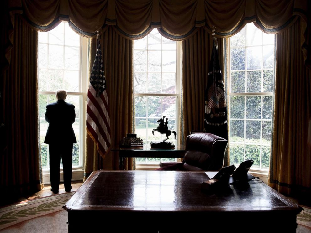 PHOTO: President Donald Trump poses for a photograph in the Oval Office, April 19, 2017.