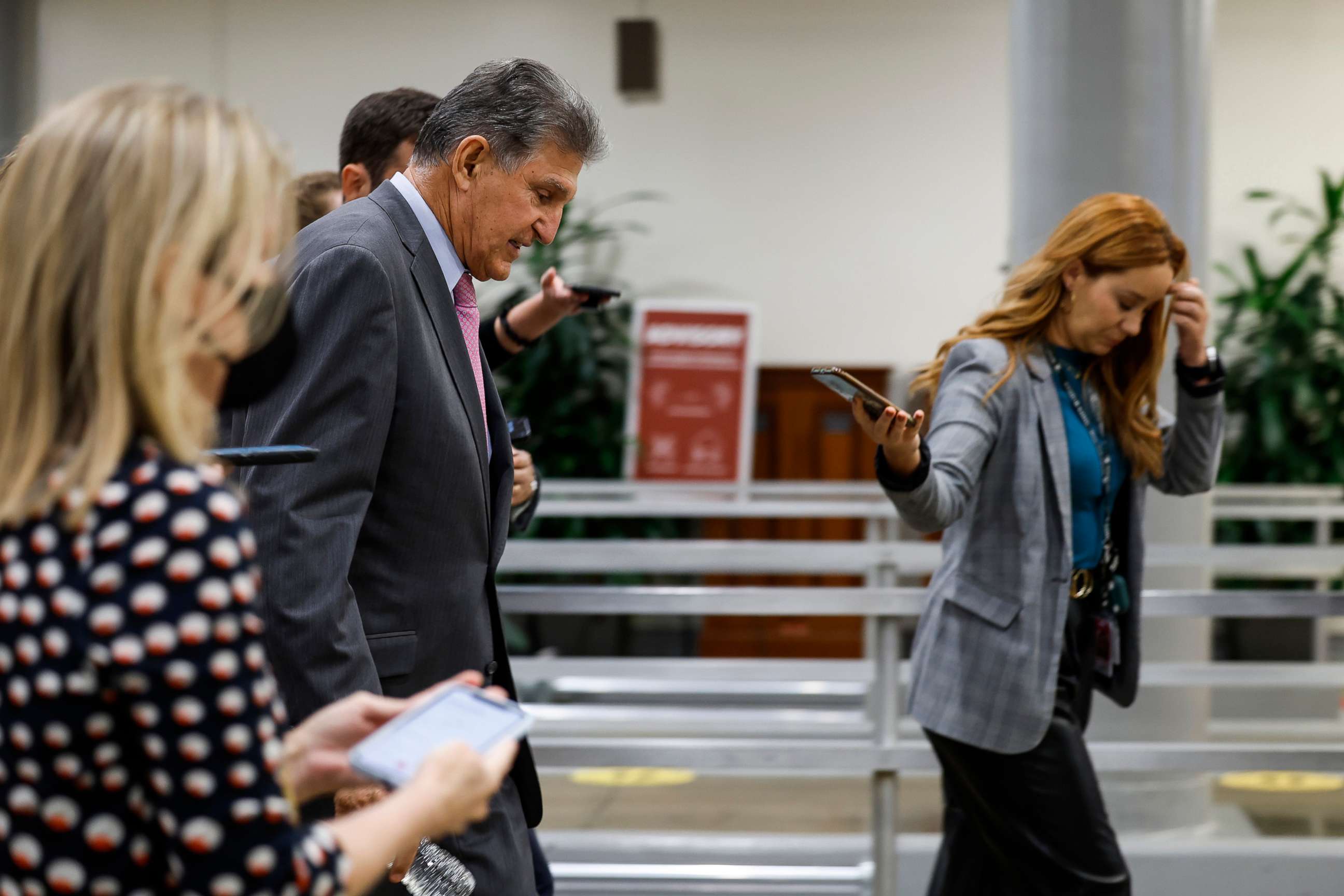 PHOTO: Sen. Joe Manchin is followed by reporters as he walks through the Senate Subway of the Capitol, Sept. 27, 2022.