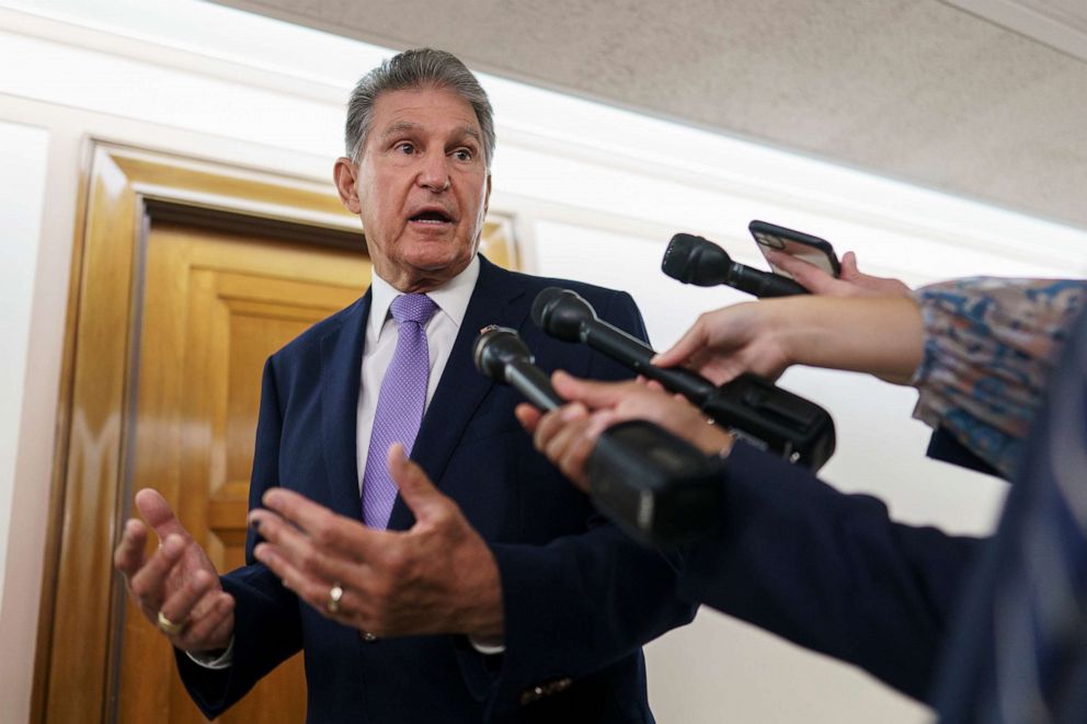 PHOTO: Sen. Joe Manchin talks to reporters outside a hearing room, July 21, 2022, at the Capitol in Washington, D.C.