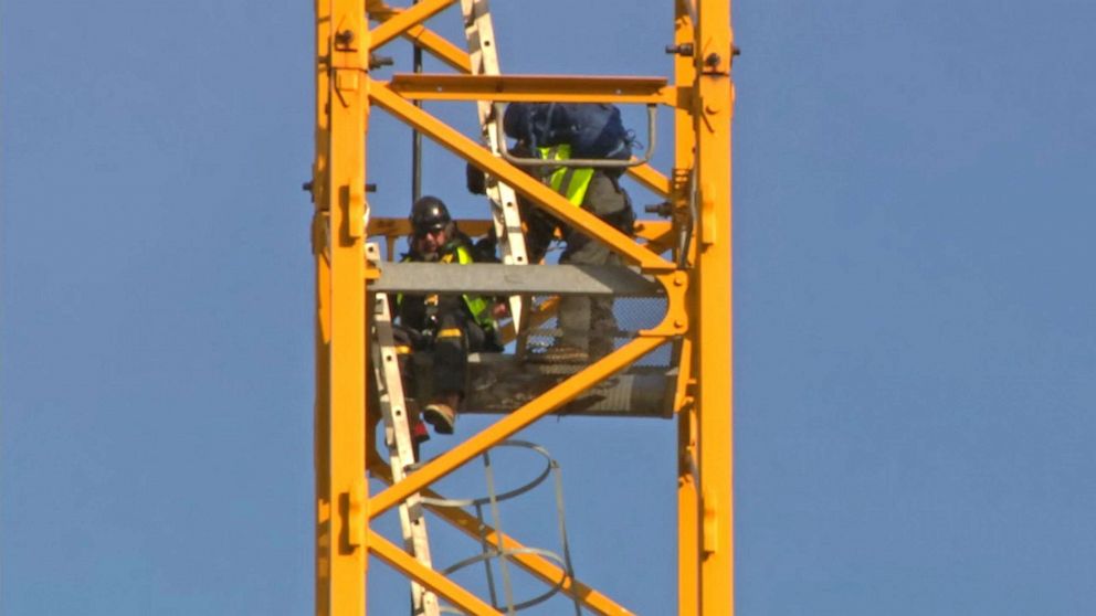 PHOTO: Manuel Oliver comes down from a crane near the White House after displaying a banner asking government to prioritize gun violence prevention, in Washington, D.C., Feb. 14, 2022. Oliver's son Joaquin Oliver was killed in the Parkland School shooting