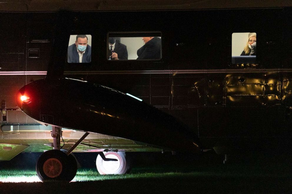 PHOTO: President Donald Trump, center, is seen seated inside Marine One helicopter, not wearing a face mask, as he and members of his staff, including White House director of social media Dan Scavino, left, arrive at the White House, Oct. 1, 2020.