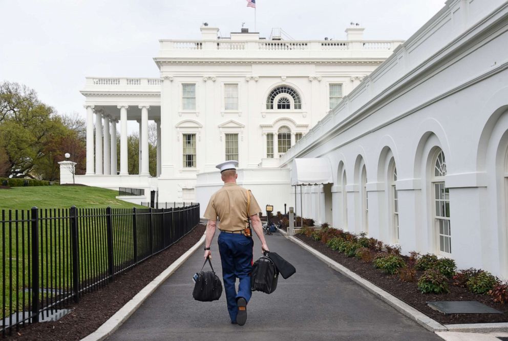 PHOTO: In this April 22, 2018, file photo, a US Marine carries the nuclear codes to the White House in Washington, DC.