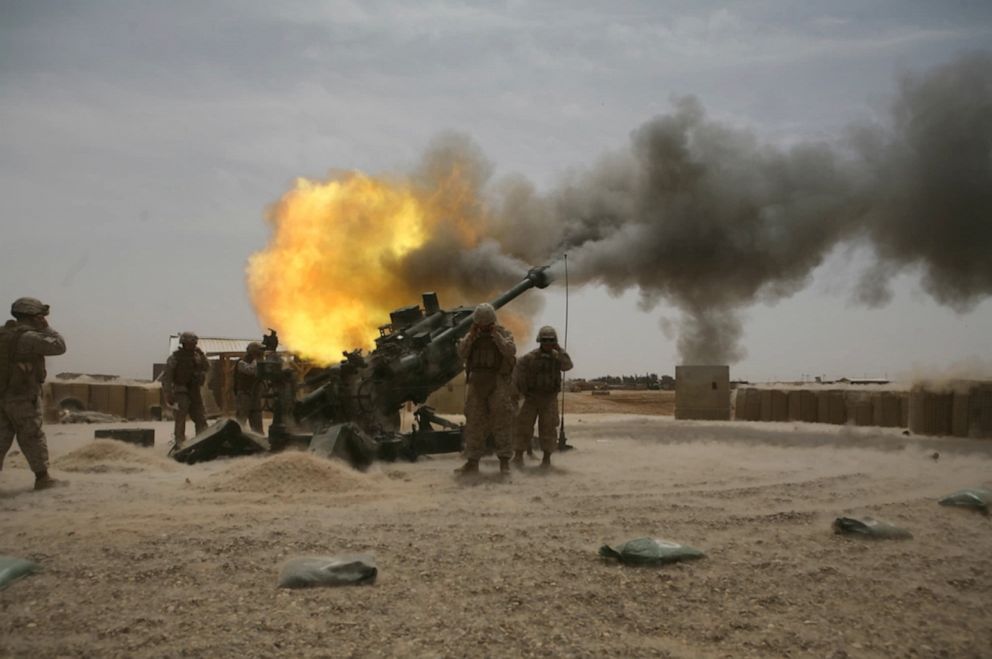 PHOTO: Marines from Battery M, 3rd Battalion, 11th Marine Regiment fire an M777 howitzer during a training exercise aboard Camp Fallujah, Iraq, April 19, 2008.